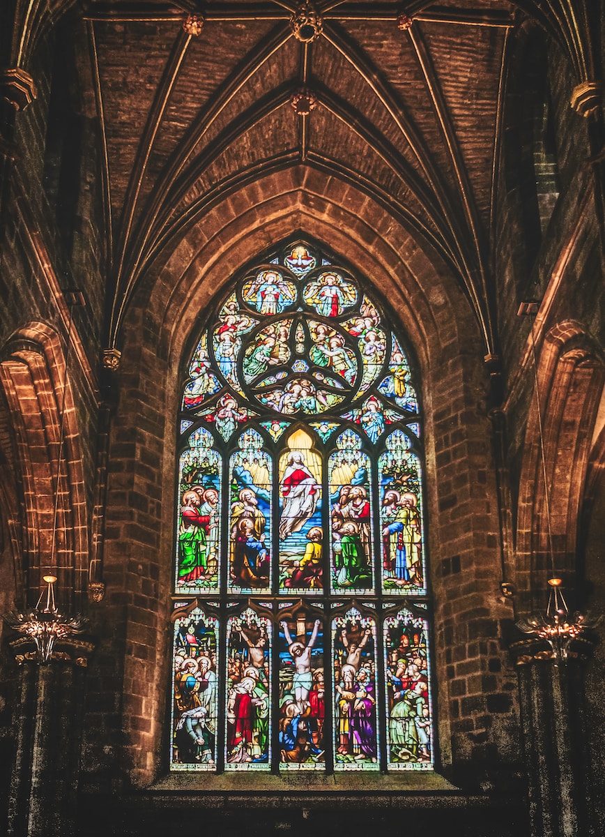 a large stained glass window inside of a church